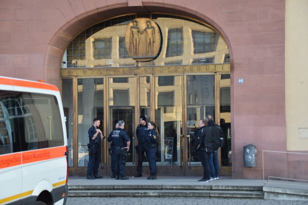 Macheten-Angriff: Frau hatte Täter zuvor angezeigt - Einsatzkräfte der Polizei stehen vor der Universität in Mannheim. Das Landeskriminalamt ermittelt nun zu dem tödlichen Polizeieinsatz.