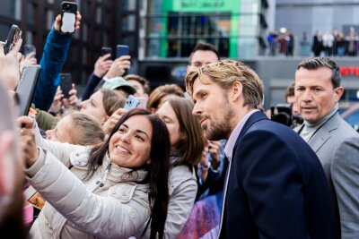 "The Fall Guy": Emily Blunt und Ryan Gosling in Berlin - Und auch Ryan Gosling posiert für Selfies mit wartenden Fans.