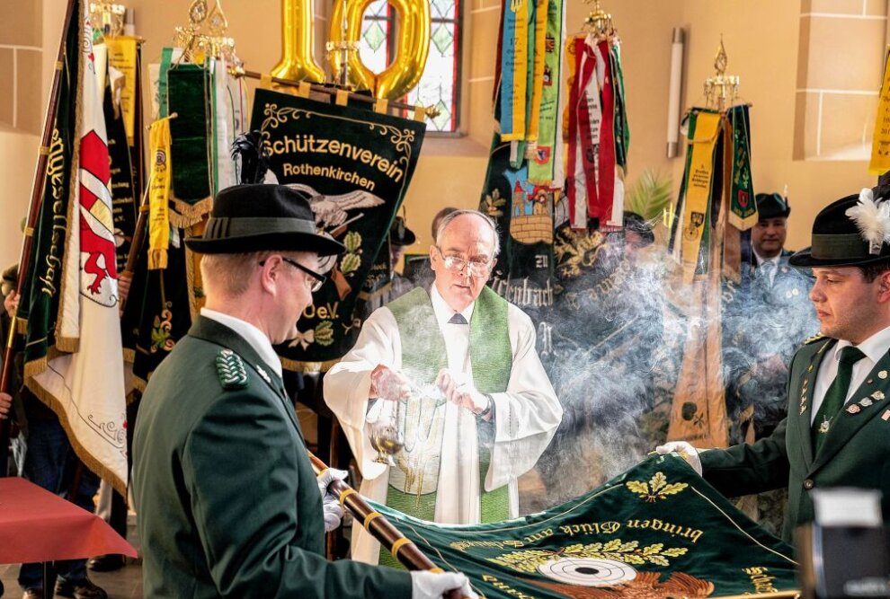Im Bild von links nehmen Danny Nagrodzki, Pfarrer Heinz-Claus Bahmann und Aron Fläschendräger die Fahnenweihe vor. Foto: Verein