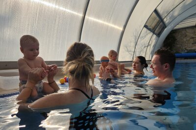 Baby-Shooting unter Wasser: Das Festhalten besonderer Momente - Schwimmtrainer Tobias Künzel zeigt den Eltern Spielideen im Wasser.
