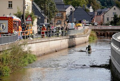 Ungewissheit über verschmutztes Gewässer in Burkhardtsdorf - Die Feuerwehr  im Einsatz beim Errichten einer Ölsperre. Foto: Harry Härtel 