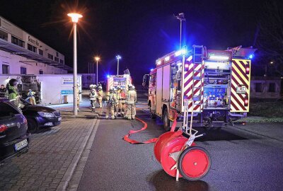 Vandalen in sächsischer Großstadt am Werk: Mülltonne angezündet und Haus beschädigt - Die Feuerwehrleute löschten den Brand zügig. Foto: Roland Halkasch