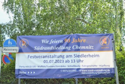 Warum Chemnitzer rund ums "Eichhörnchen" feiern - An der Zufahrt zur Siedlung von der Stollberger Straße aus wirbt ein Plakat für das große Jubiläumsfest. Foto: Jürgen Sorge